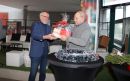 Andrzej Krzysztofiak, Przewodniczący Rady Miejskiej w Kwidzynie, wręcza kosz słodkości jednemu z organizatorów.