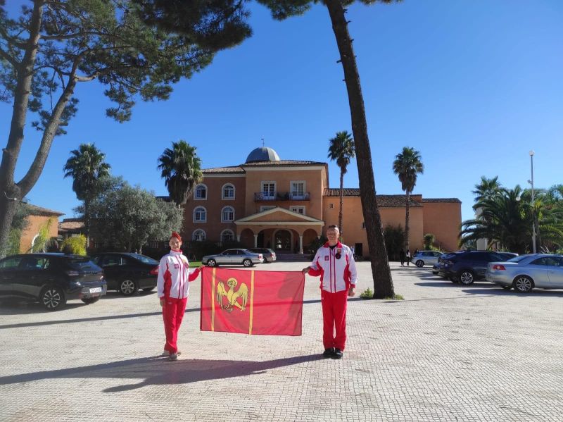 Para taneczna z Kwidzyna Monika i Mariusz Budyś w strojach reprezentacji narodowej prezentuje flagę powiatu kwidzyńskiego