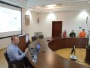 Osoba prowadząca szkolenie przy stole konferencyjnym omawiająca szczegółowe tematy objęte szkoleniem